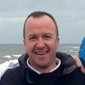 profile picture of nick foley smiling by the sea